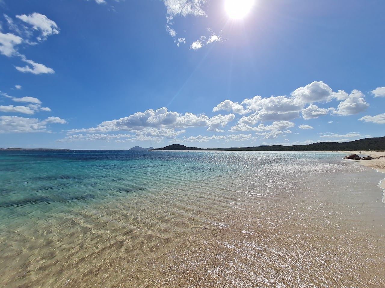 Clear turquoise shallows and pale sand of Liscia Ruja beach on the Costa Smeralda