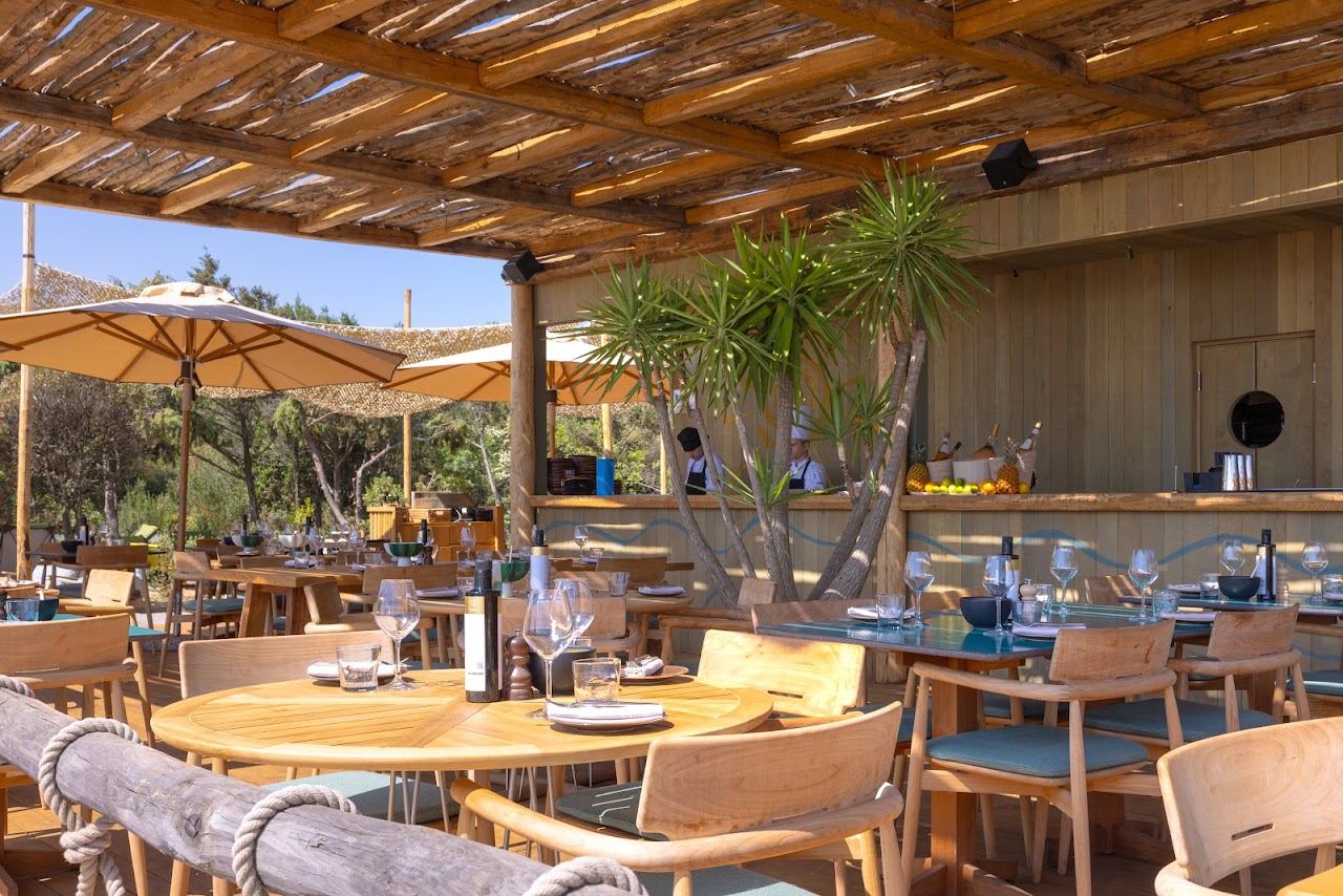 Timber pergola dining terrace of A Mare beach club among the junipers behind Liscia Ruja, Costa Smeralda