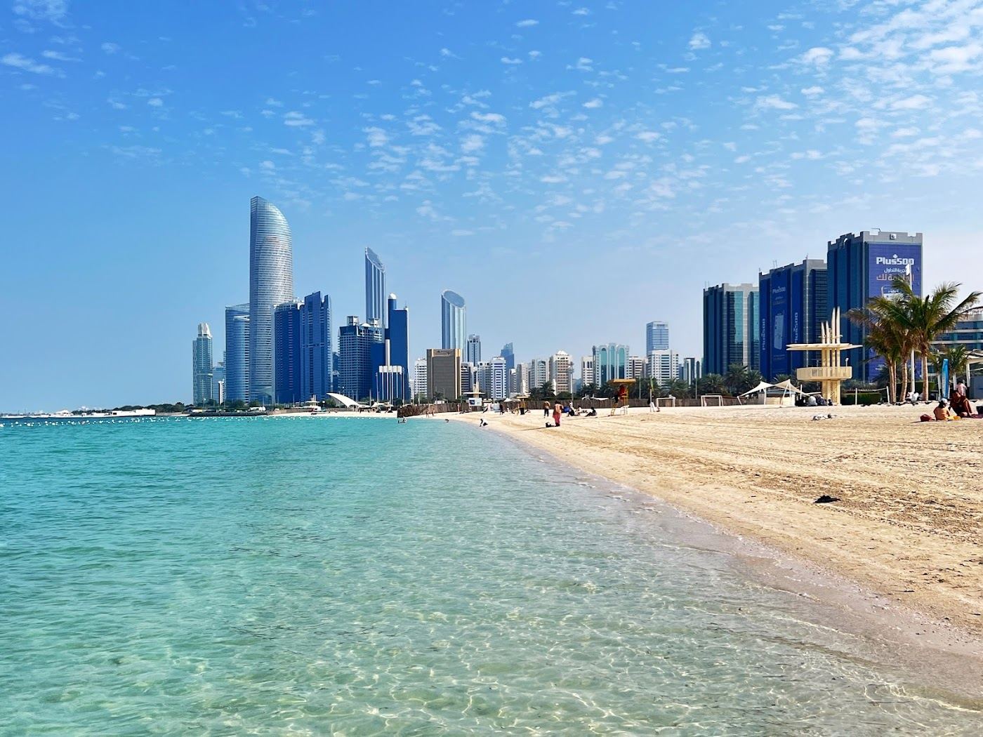 The long public sand and calm Gulf water along the Corniche in Abu Dhabi