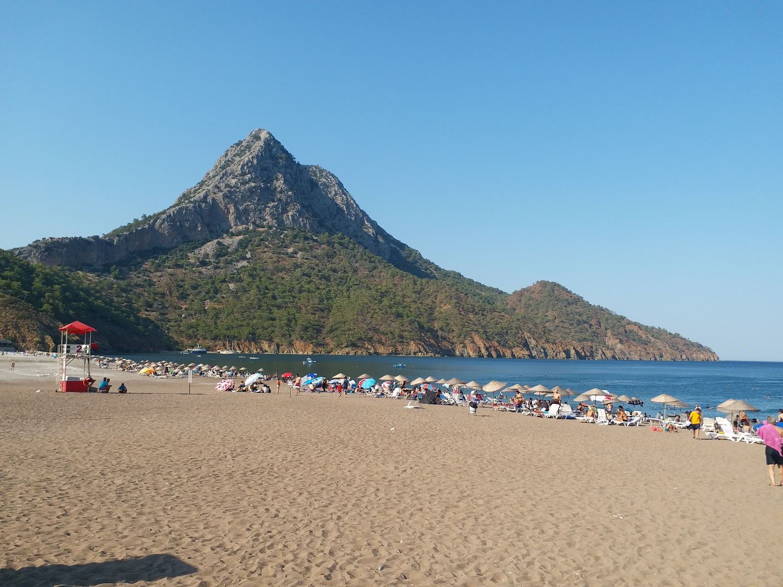 The calm crescent bay of Adrasan beach sheltered by green mountains south of Antalya