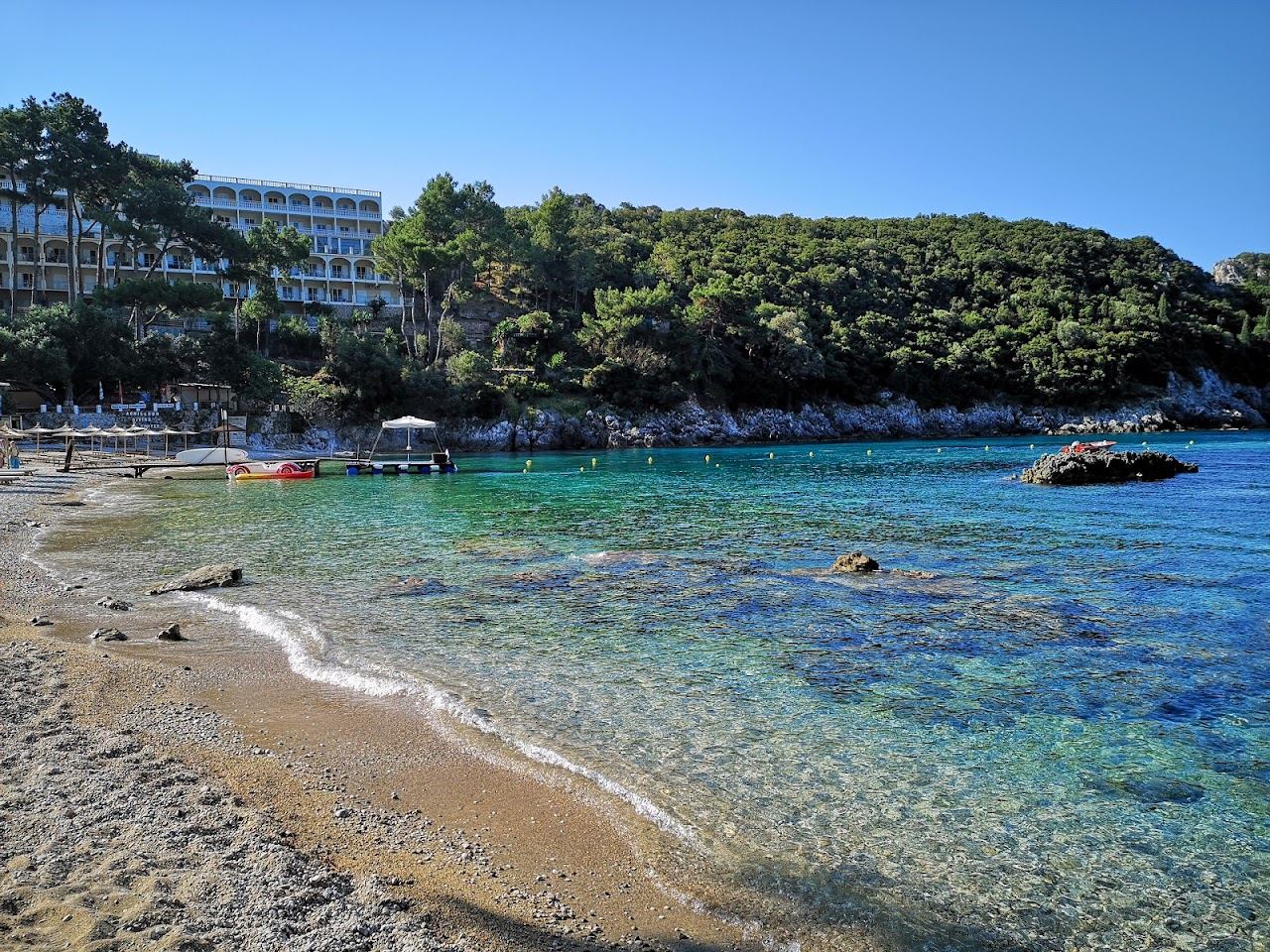 The Agia Triada inlet at Paleokastritsa in Corfu with clear water and green headlands