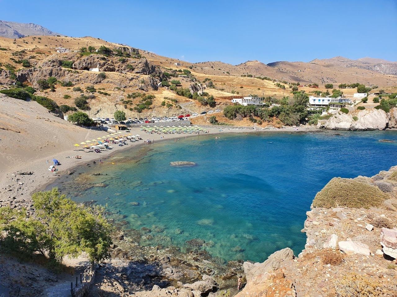 Sheltered sandy bay and tavernas above the shore at Agios Pavlos on the Crete south coast
