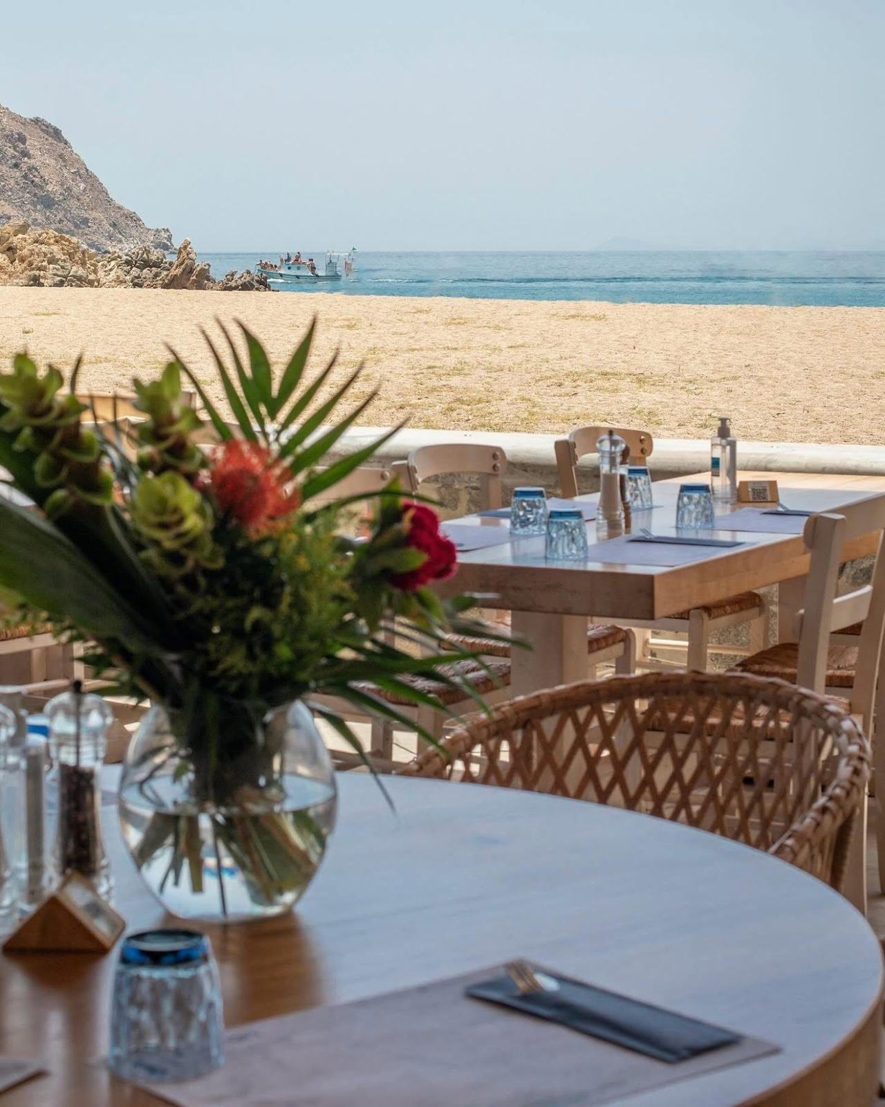 The soft sand and sheltered green hills around quiet Agrari Beach on the southeast coast of Mykonos
