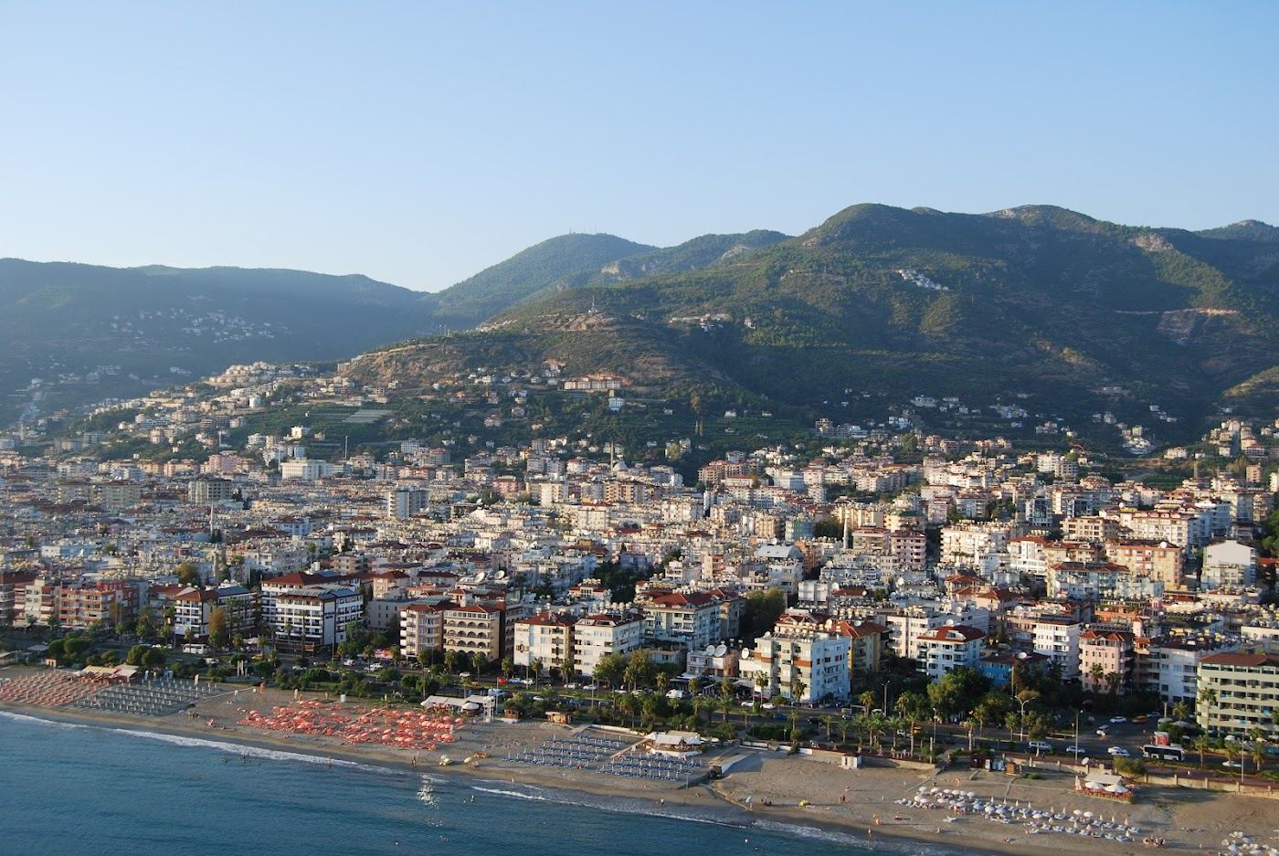 A long free public beach of golden sand and clear water on the Alanya coast
