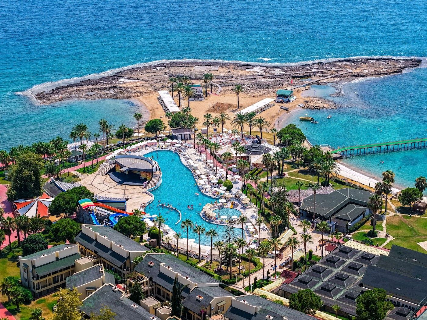 Fine golden sand and shallow water backed by pines at Incekum Beach west of Alanya