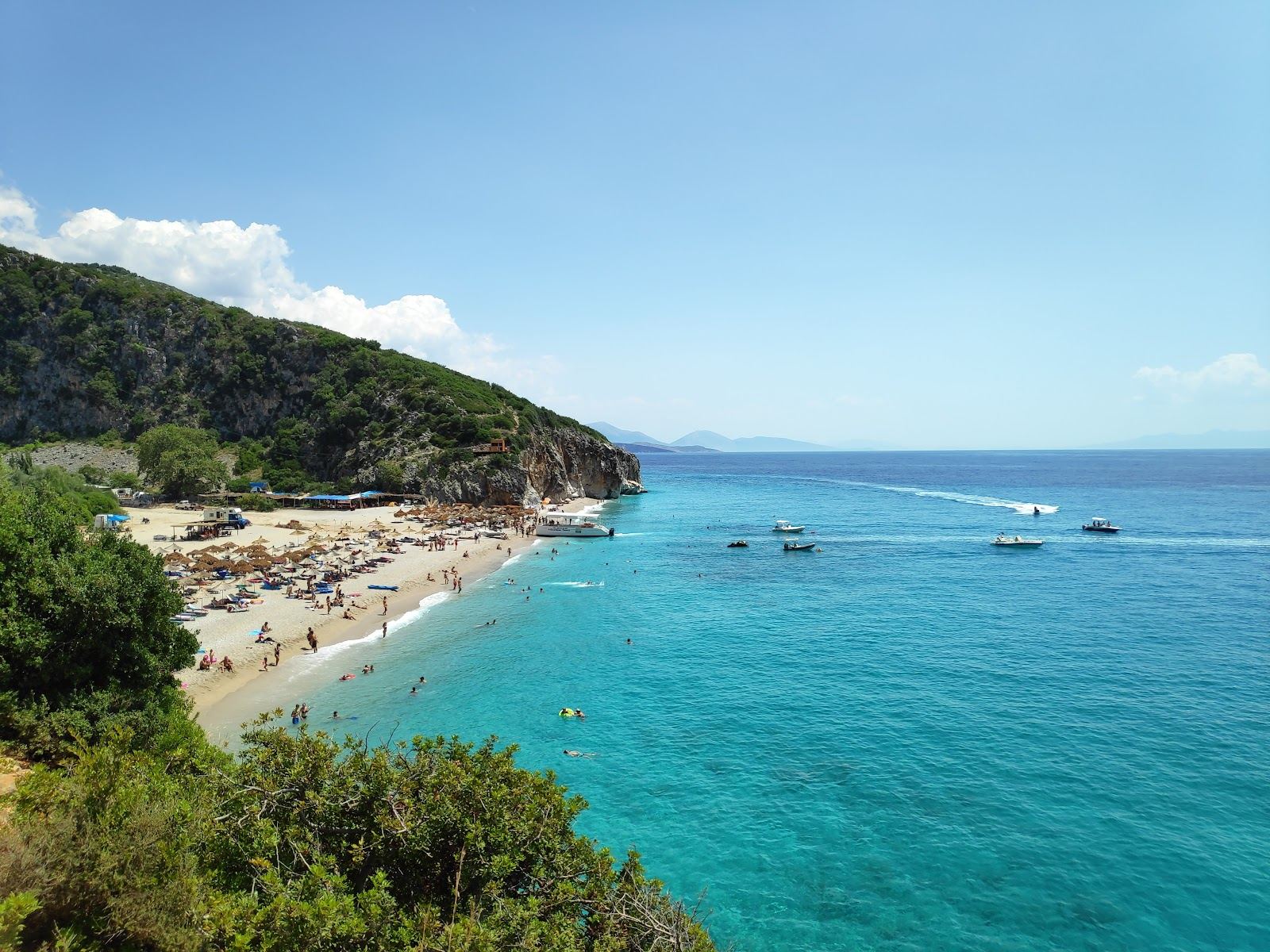 A turquoise pebble cove framed by cliffs on the Albanian Riviera