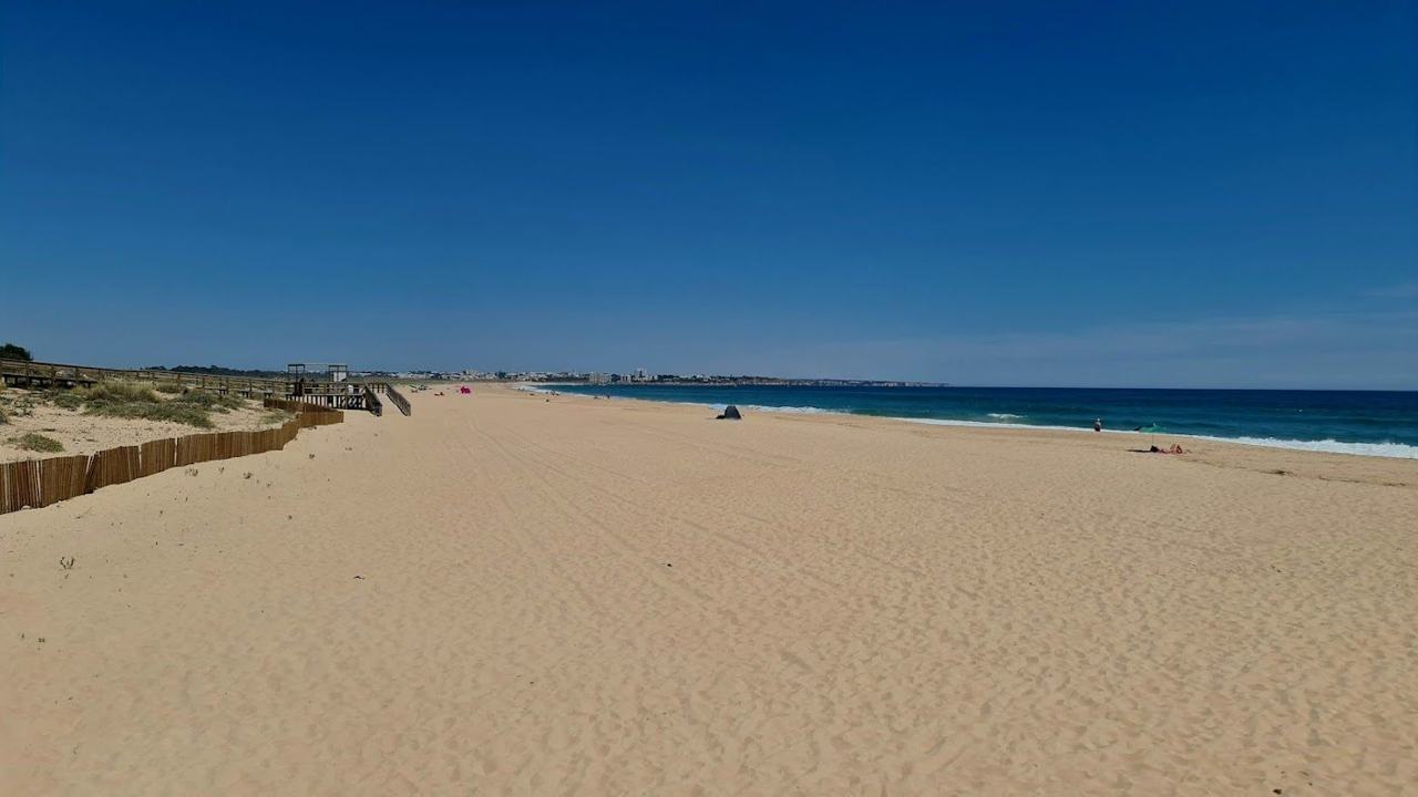 Wide open sand and clear water along Meia Praia near Lagos in the Algarve
