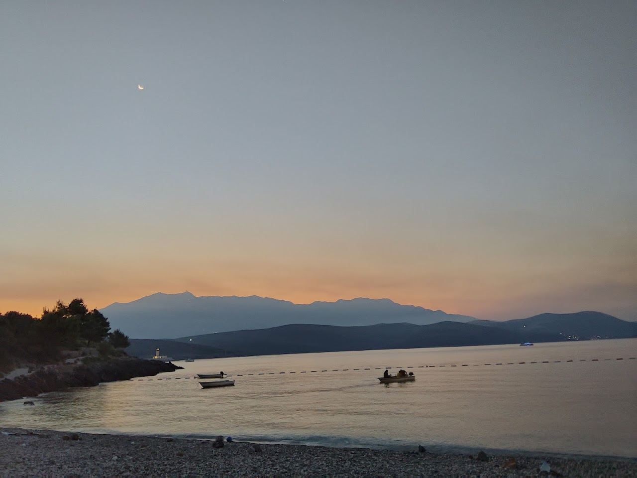 Clear shallow water and the pebble shore of Oblatno bay on the Lustica peninsula