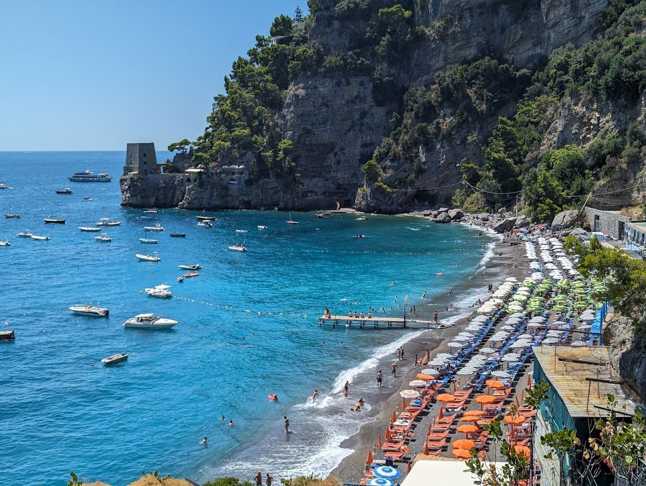 Evening light over the cliffs and water at Fornillo beach in Positano on the Amalfi Coast