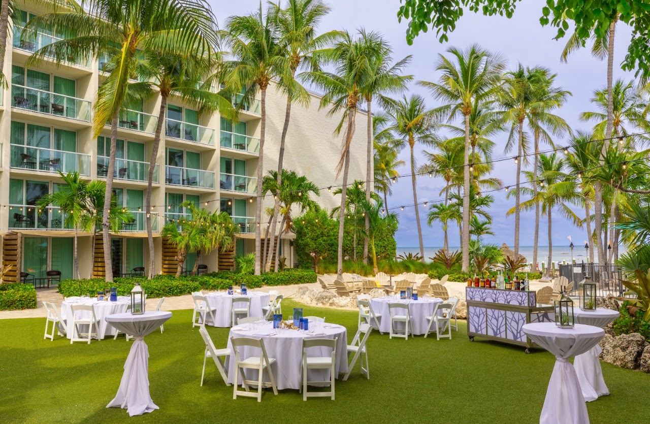 Pool, loungers and palms beside the water at Amara Cay Resort in Islamorada