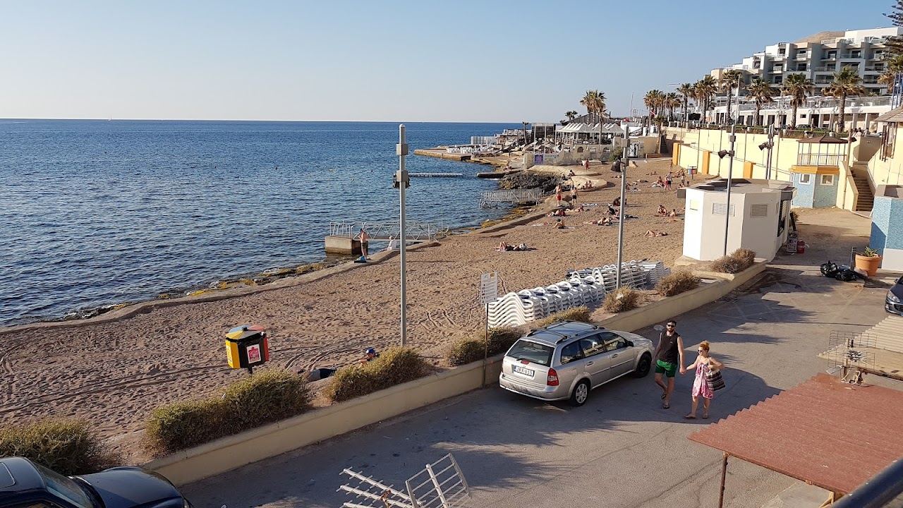The built perched beach and rocky shelf along the Bugibba and Qawra seafront in St Paul's Bay, Malta