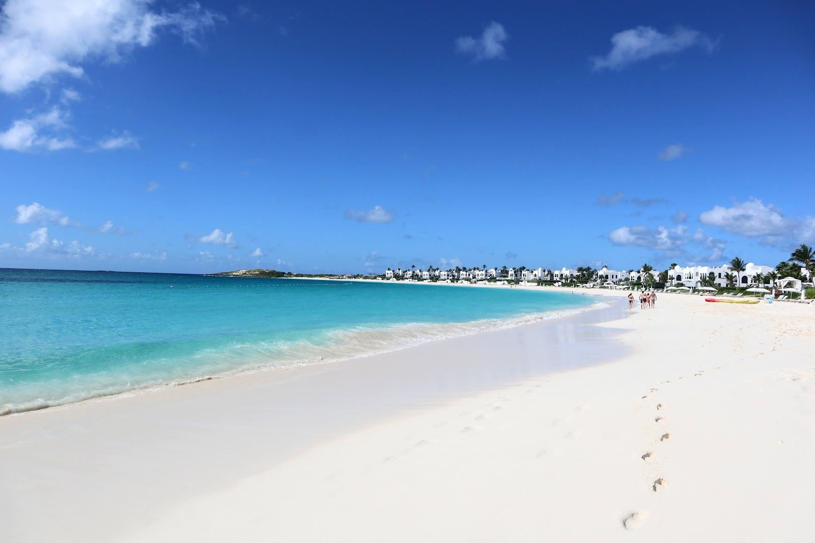 A sheltered crescent of soft white sand and flat clear water at Maundays Bay, Anguilla