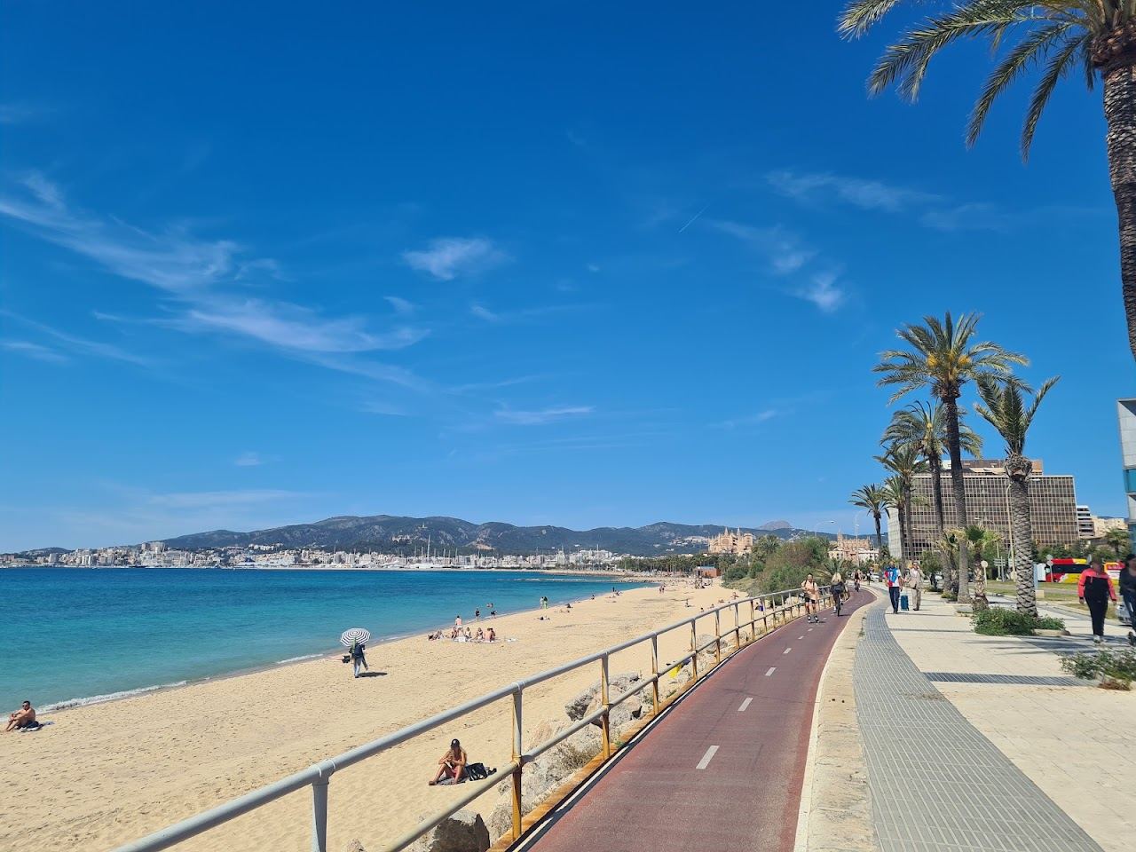 Can Pere Antoni city beach with Palma Cathedral on the skyline behind the sand