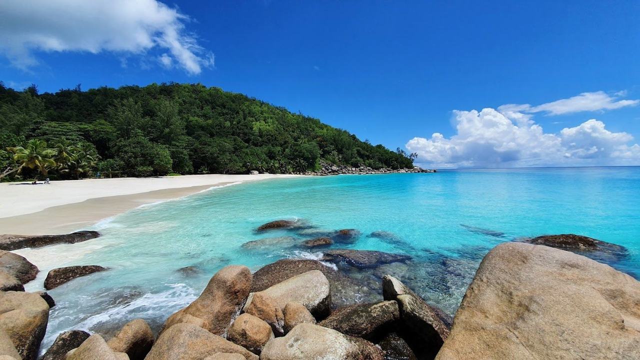 White sand, clear turquoise water and green headlands at Anse Georgette on Praslin in Seychelles