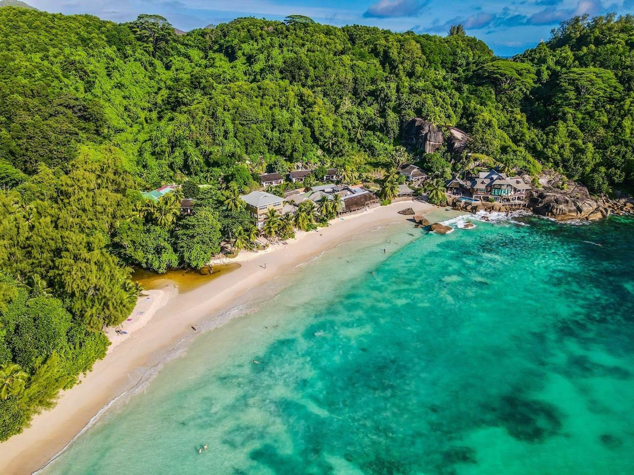 Palm backed crescent and open surf at Anse Takamaka on south west Mahe