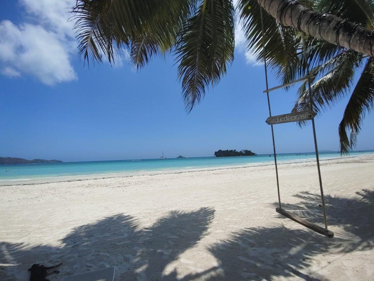 Long pale sand and shallow calm lagoon at Anse Volbert, also called Cote d'Or, on Praslin in Seychelles