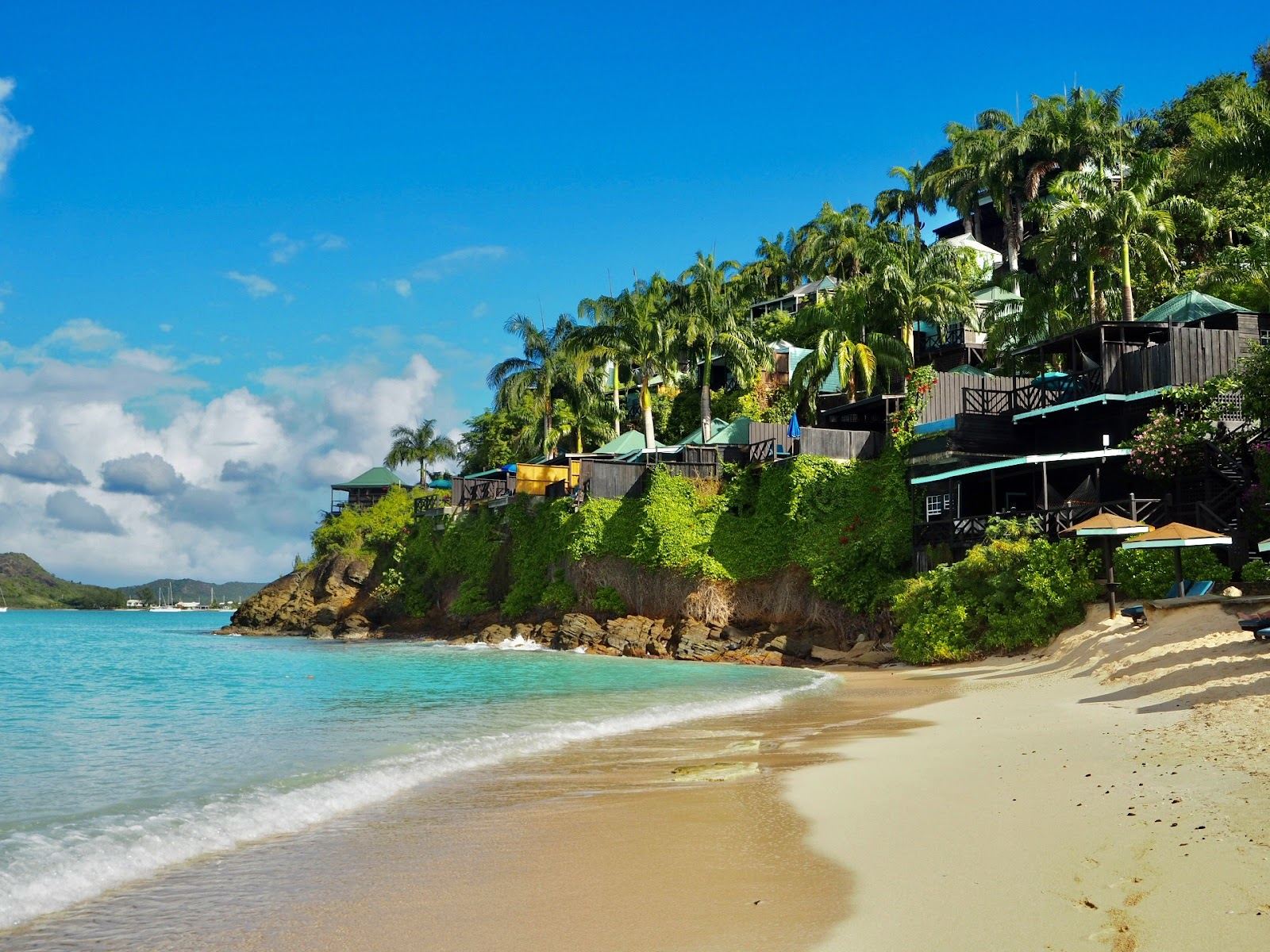 Calm shallow turquoise water and soft pale sand at Valley Church Beach on the calm west coast of Antigua