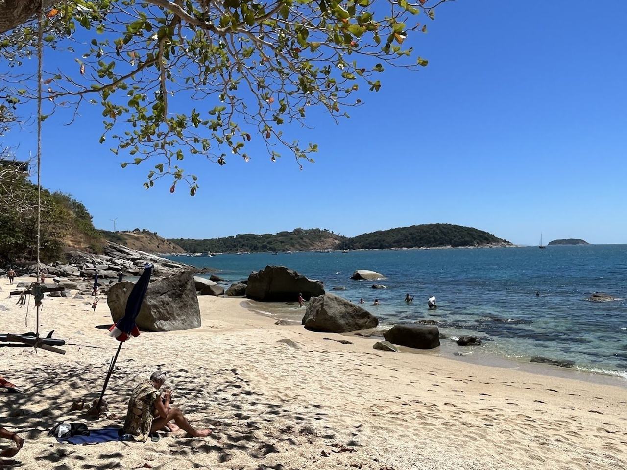 Clear water over rocks at the small snorkelling cove of Ao Sane Beach in Phuket