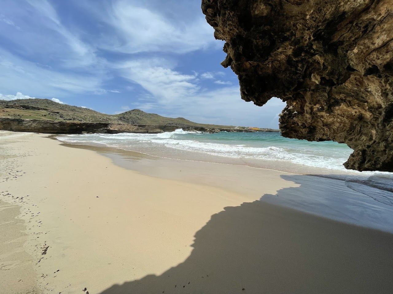 Atlantic waves breaking below coral stone cliffs at the wild Andicuri Beach on the north coast of Aruba