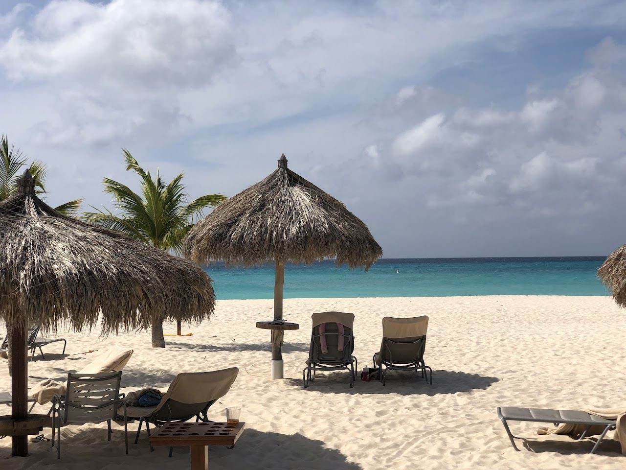 Soft white sand and calm turquoise water on the quiet low rise coast at Manchebo Beach in Aruba