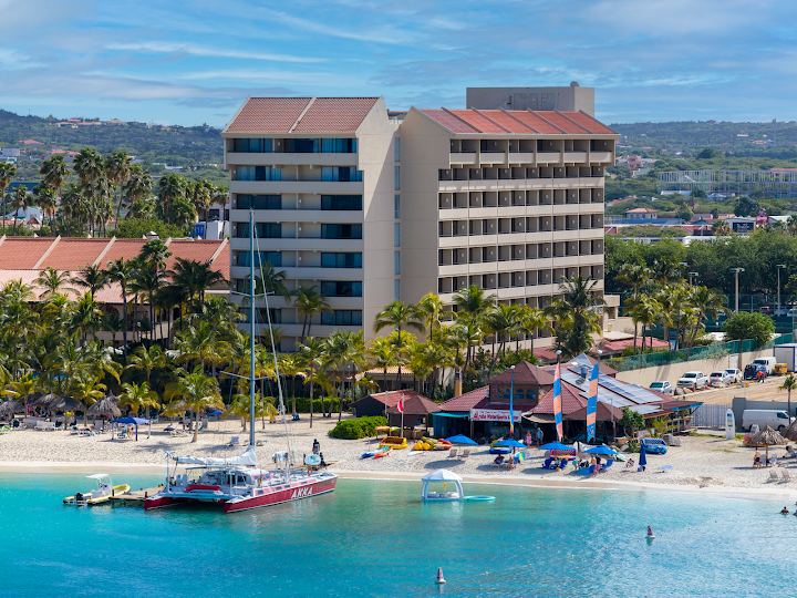 Paddleboards and calm clear water along the resort strip of Palm Beach in Aruba