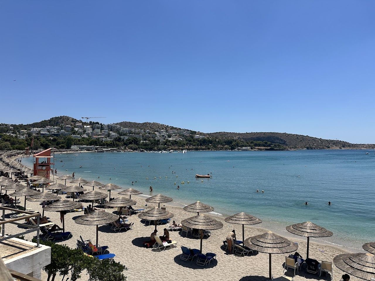 Clear blue water and pine backed sand on the Athens Riviera at Vouliagmeni