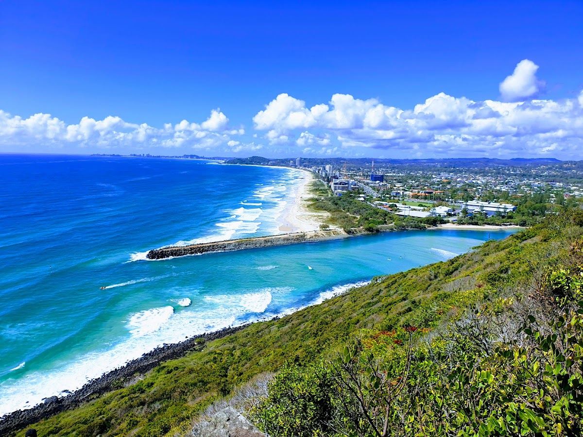 Surfers on the point break below the headland reserve at Burleigh Heads