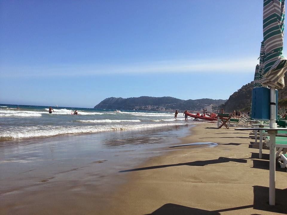 Rows of umbrellas and loungers on the white sand of Bagni Lido in Alassio