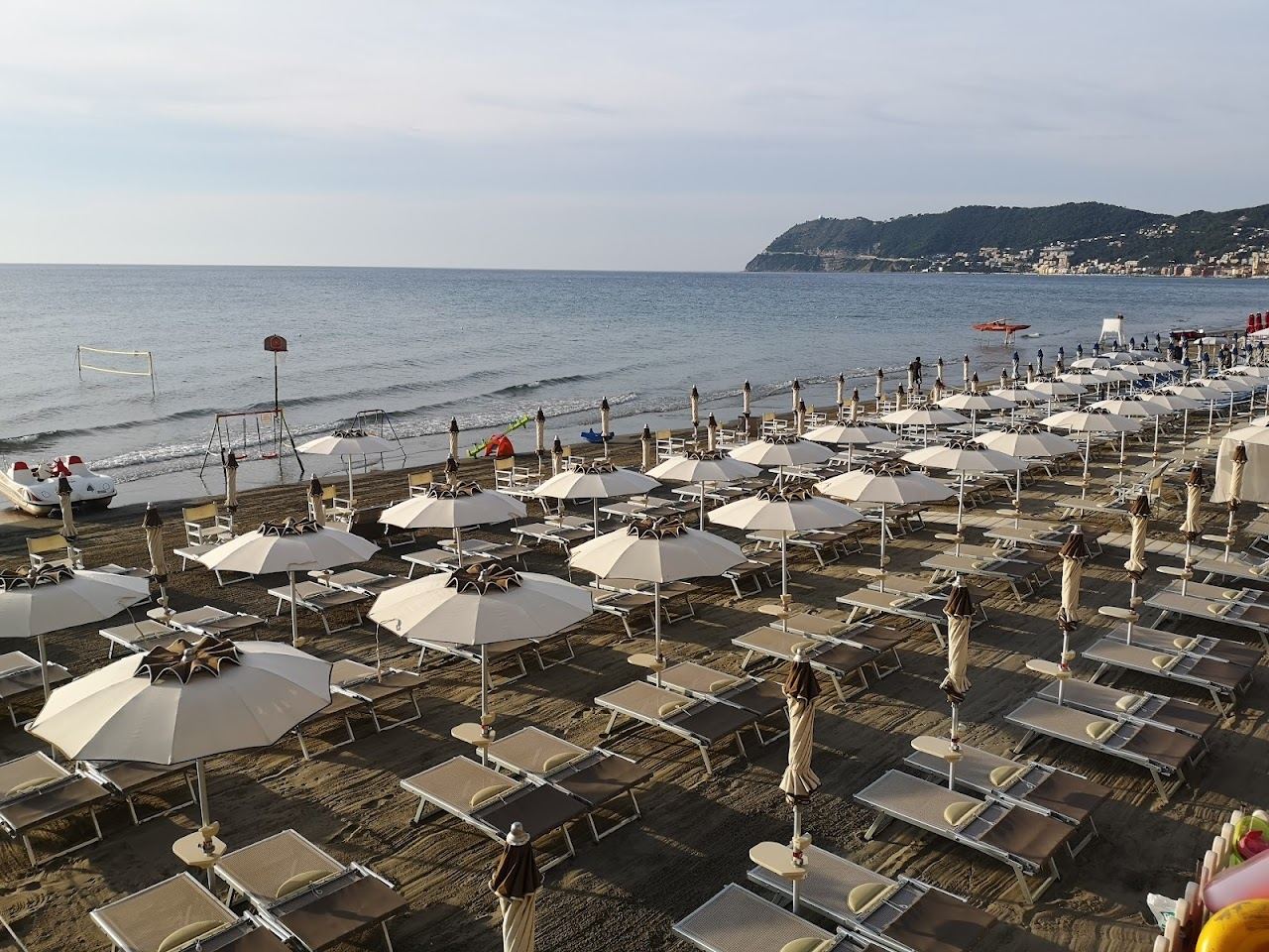 Rows of umbrellas and loungers on the sand at Bagni Londra on the Alassio seafront, Liguria