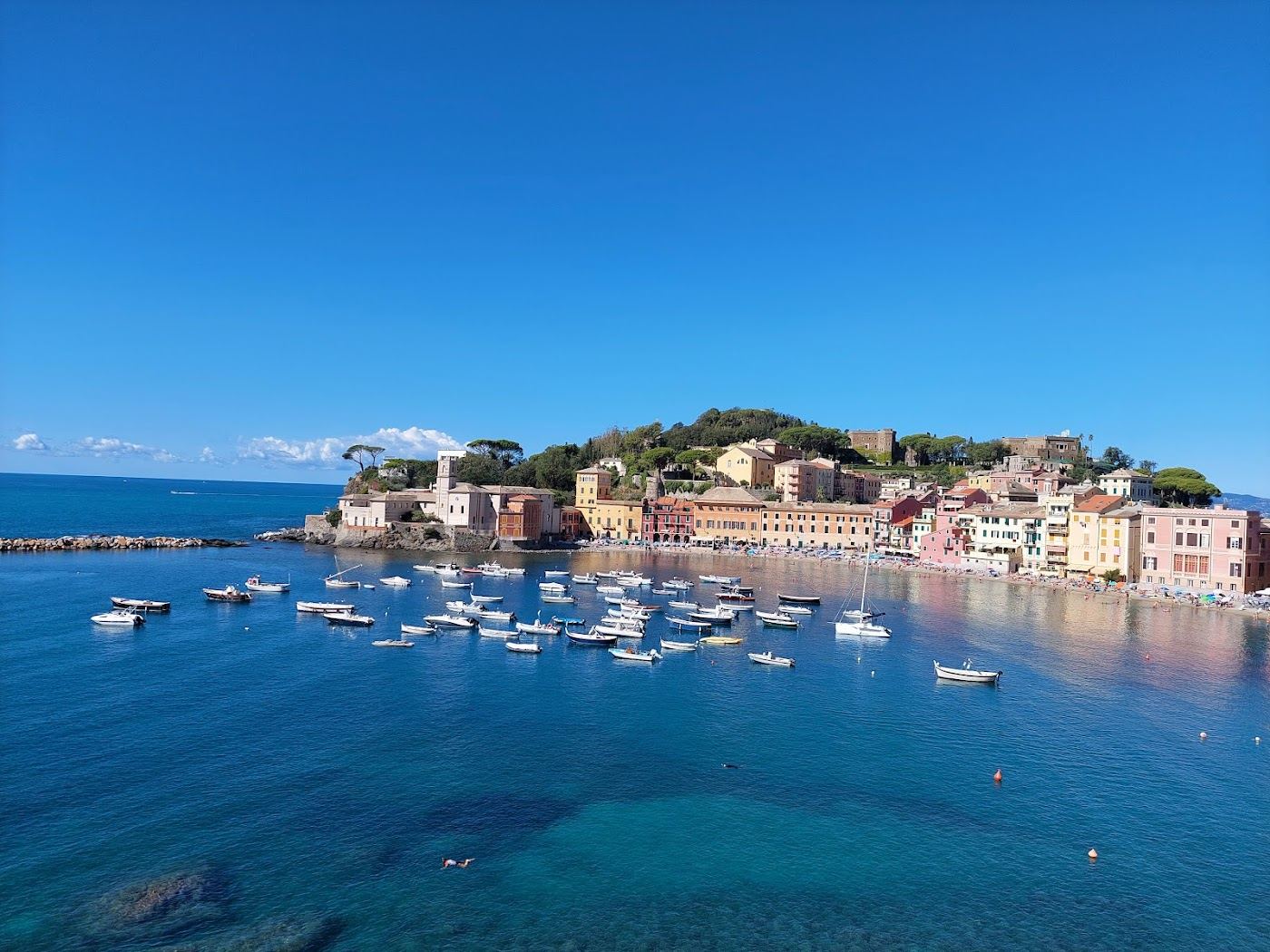 Colourful houses leaning over the sheltered sand of the Bay of Silence at Sestri Levante