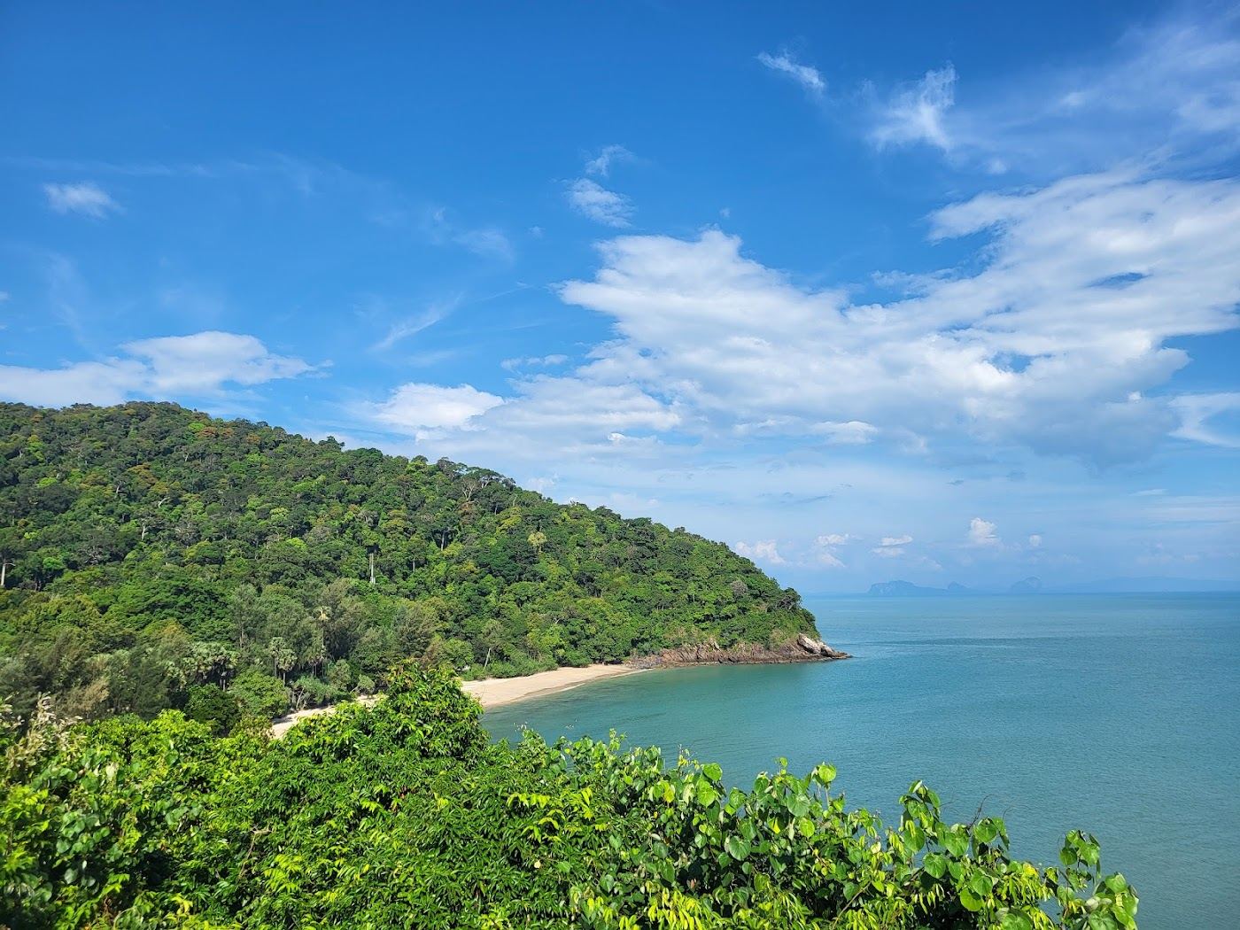 Quiet sand and forested headlands at Bamboo Bay on southern Koh Lanta
