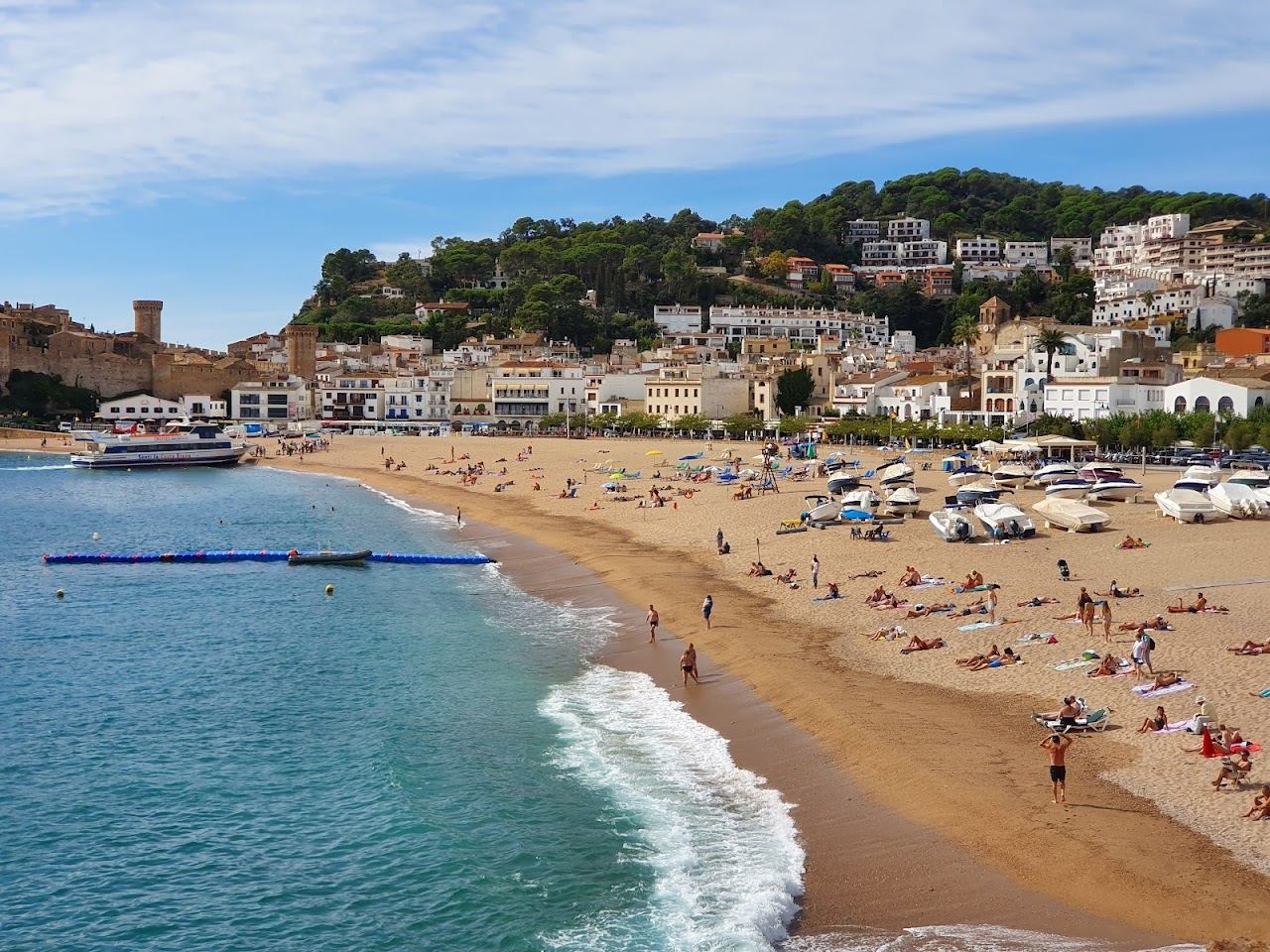 A curve of sand below the medieval walled headland of Tossa de Mar on the Costa Brava