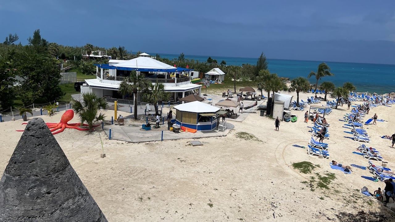 Beach loungers and clear water at Snorkel Park Beach in the Royal Naval Dockyard in Bermuda