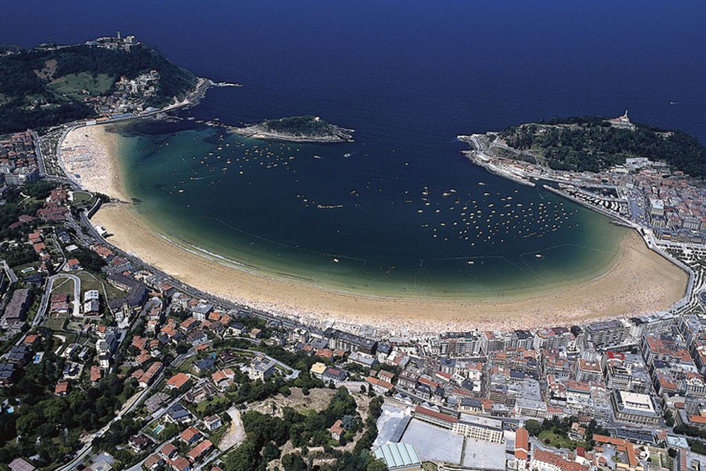 The wide golden crescent and calm sheltered water of La Concha bay in San Sebastian, Spain