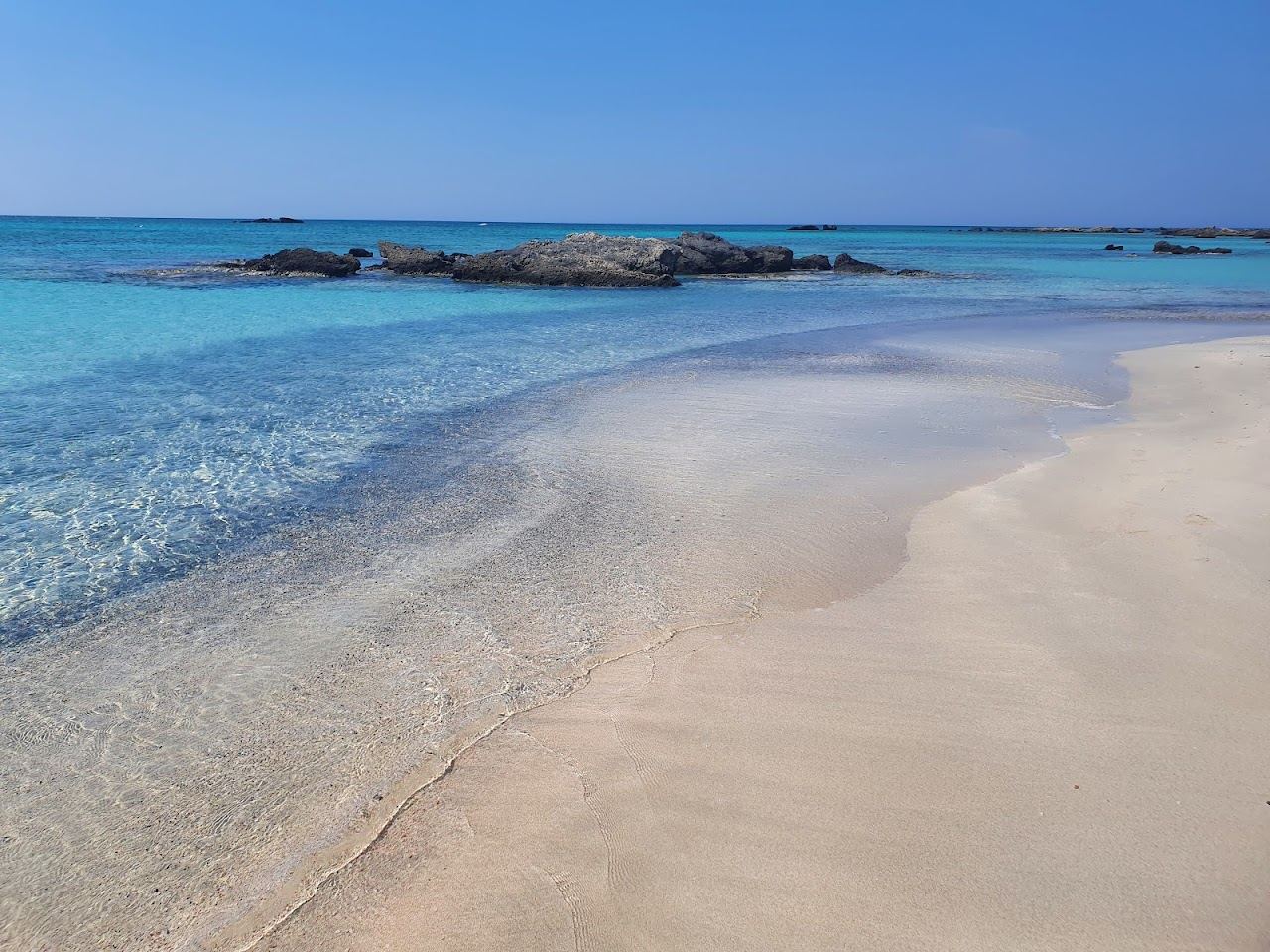 Pink tinged white sand and shallow turquoise lagoon water at Elafonissi on the southwest tip of Crete