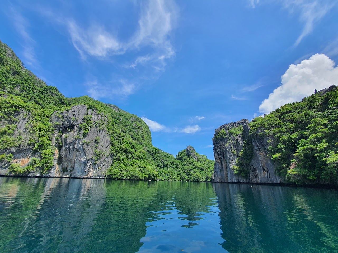 Big Lagoon emerald water ringed by karst cliffs near El Nido Palawan