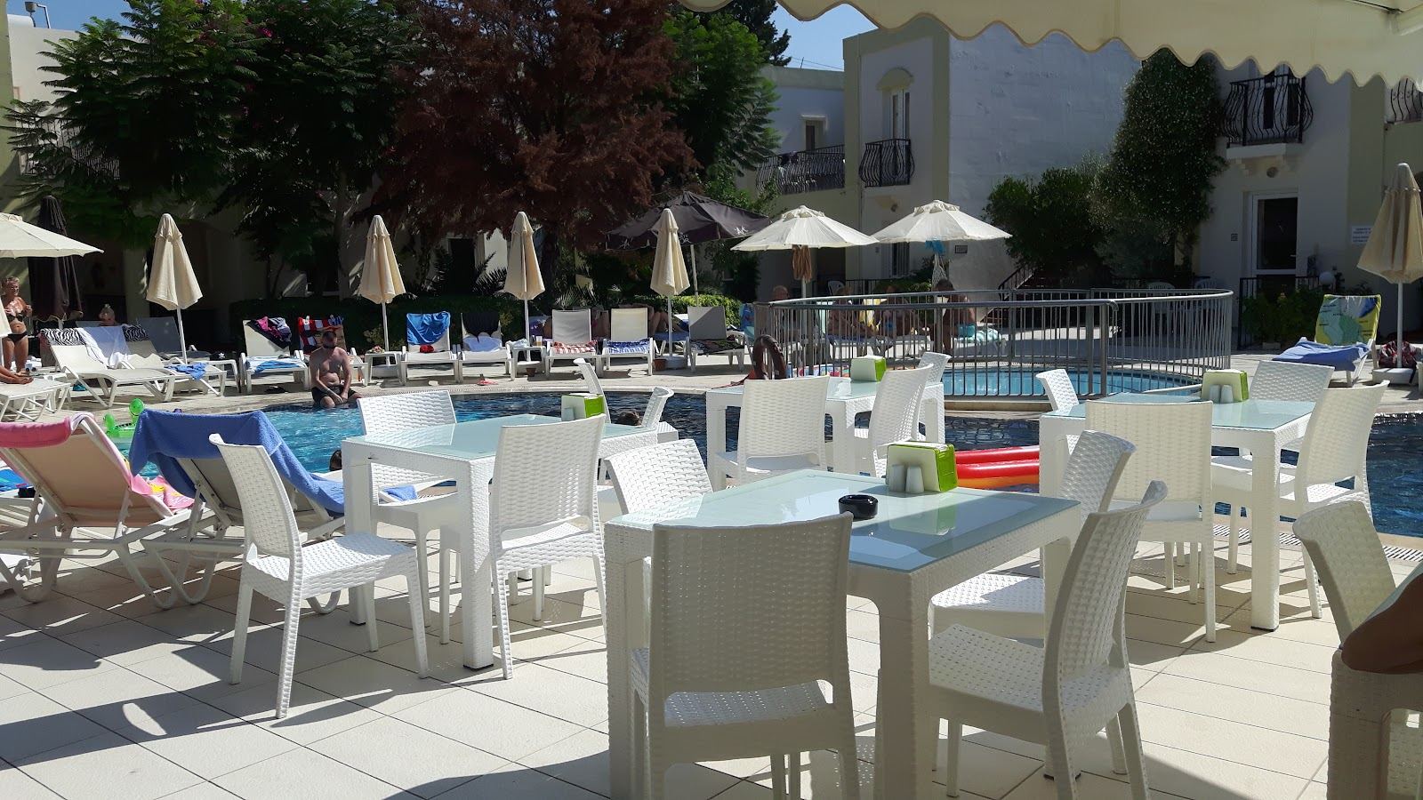 Calm shallow bay and cafe backed promenade at Bitez beach on the Bodrum peninsula