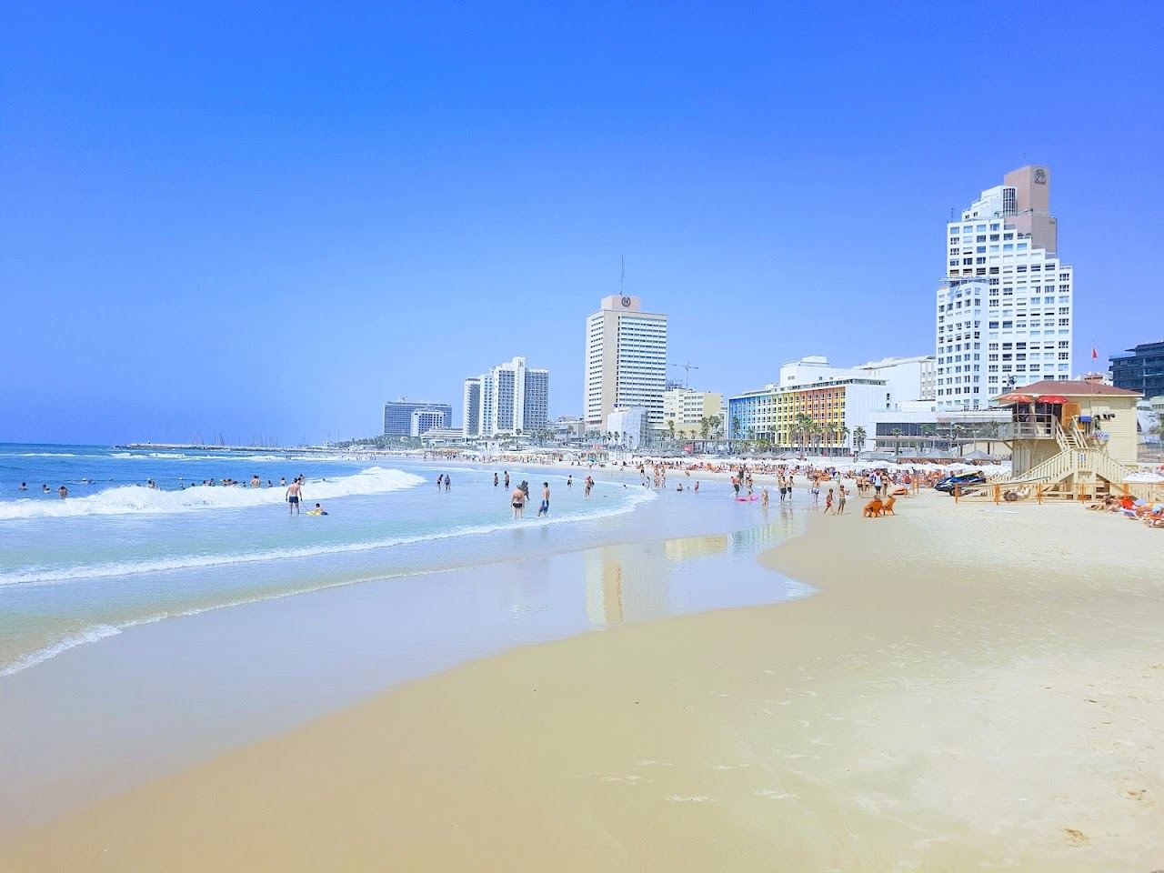 The promenade, sunbeds and soft sand of Bograshov beach in central Tel Aviv