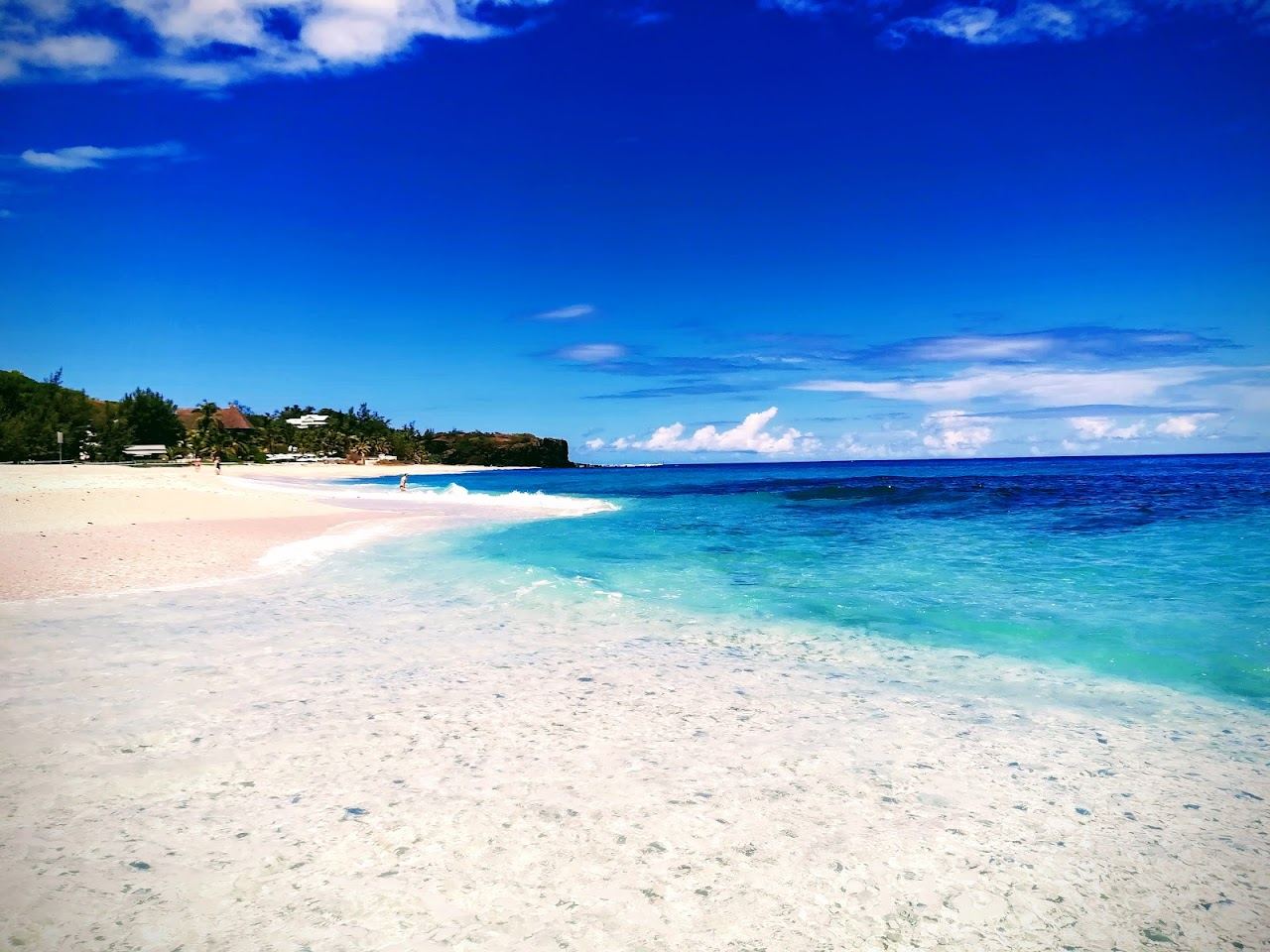 The white sand and beachfront esplanade restaurants at Boucan Canot beach in Reunion