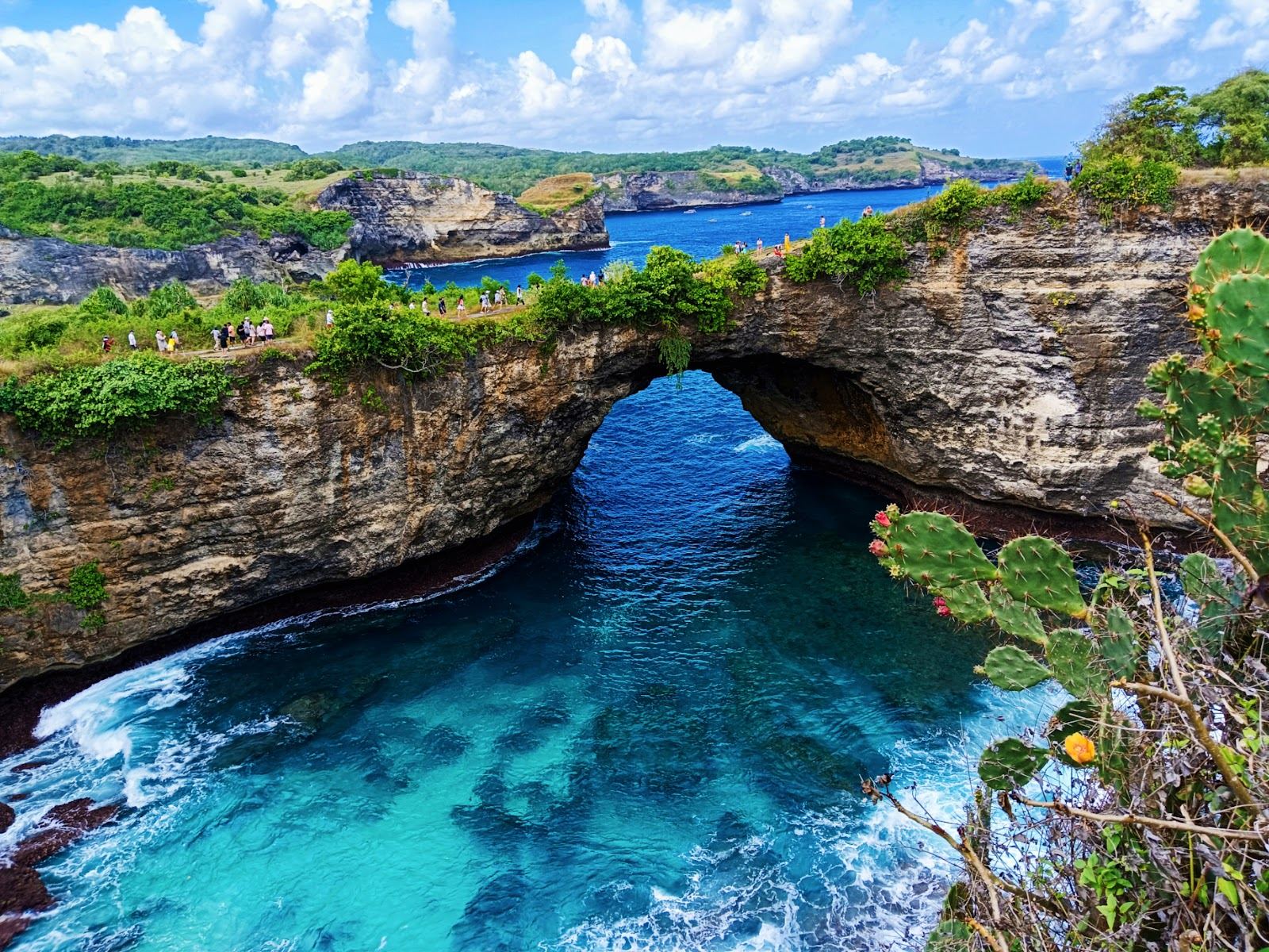 The natural rock arch and circular cliff cove of Broken Beach on Nusa Penida