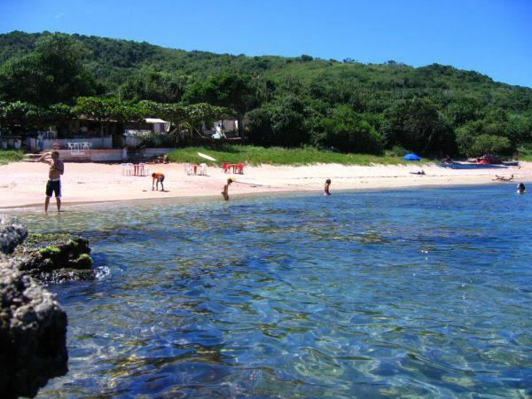 Clear calm water and rocky edge for snorkelling at Praia do Forno in Buzios