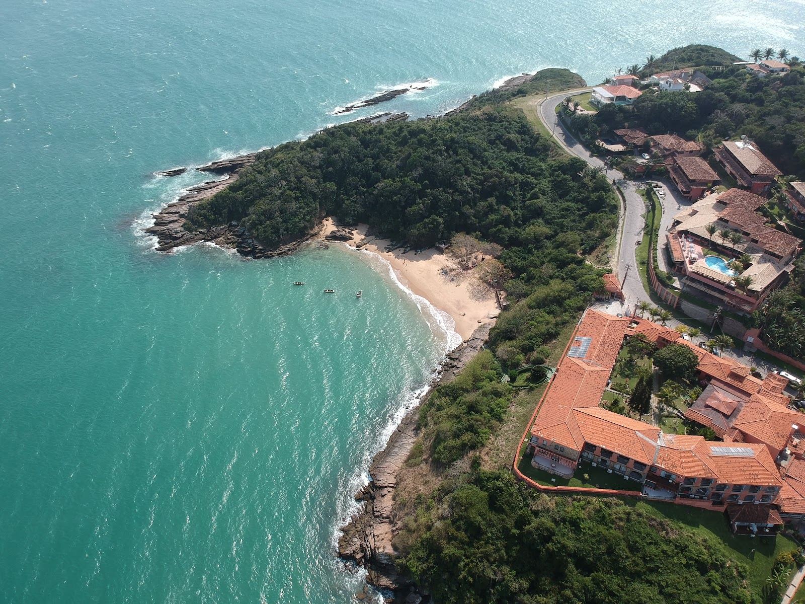 Calm clear green water and soft pale sand at Joao Fernandes beach on the Buzios peninsula in Brazil