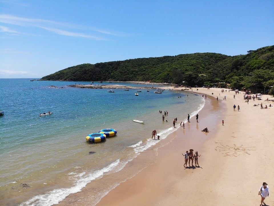 Calm clear water and rocky headland at Praia da Tartaruga in Buzios