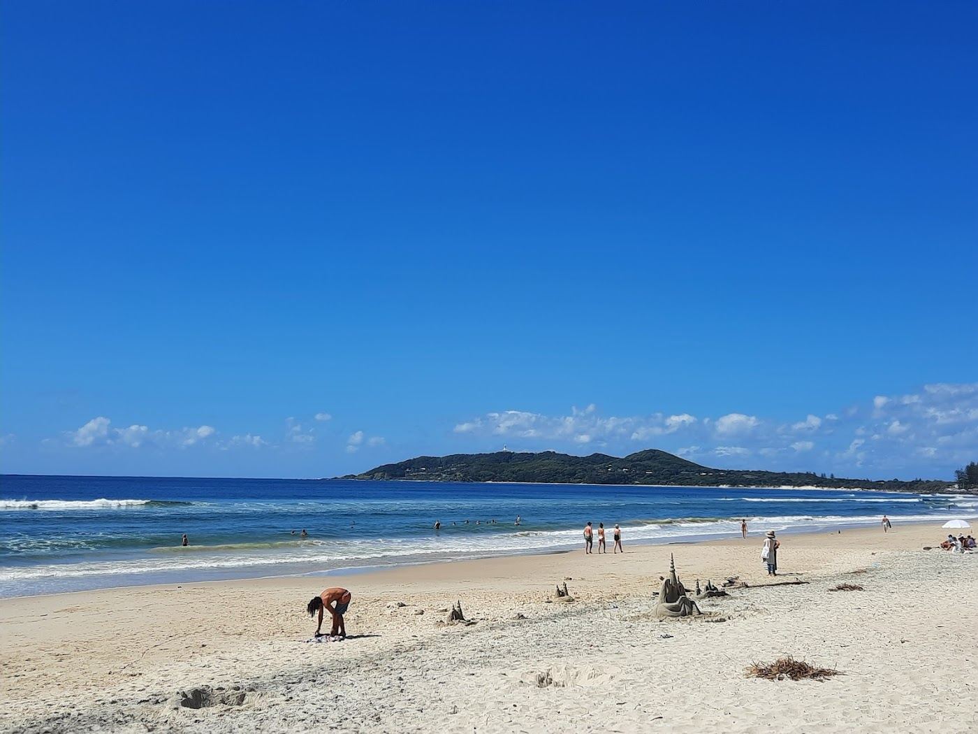 The wide quiet sand of Belongil Beach near Byron Bay under a soft evening sky