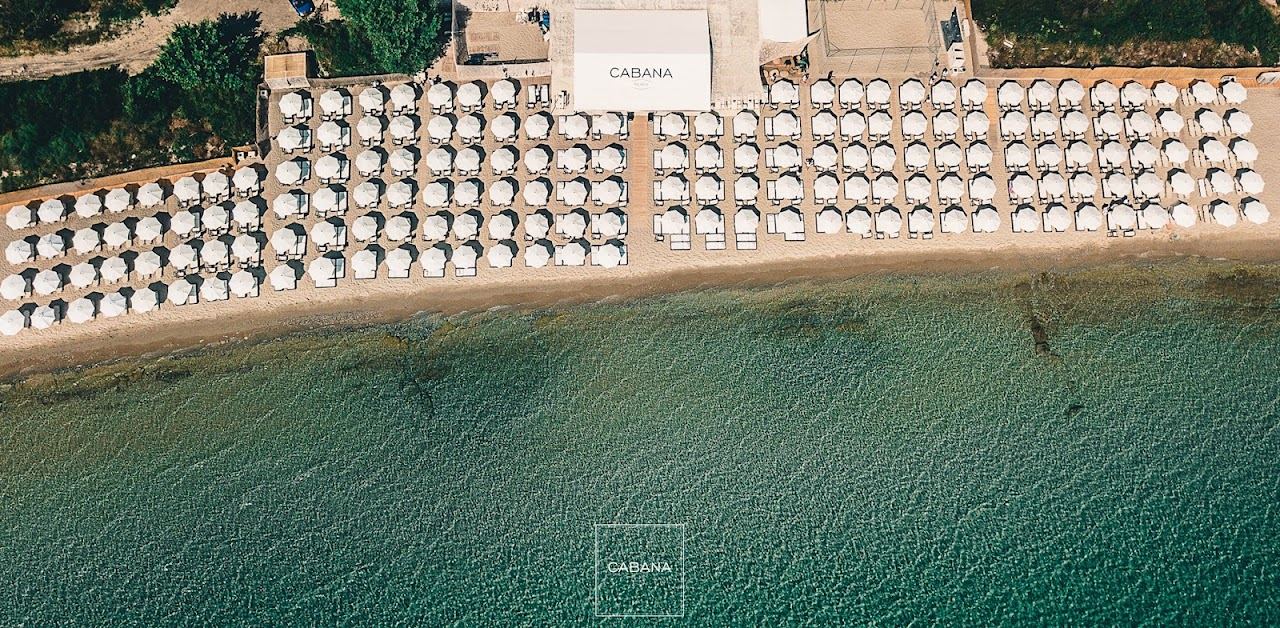 Rows of oversized sunbeds and umbrellas at Cabana Beach Club on the Paliouri sand in Halkidiki
