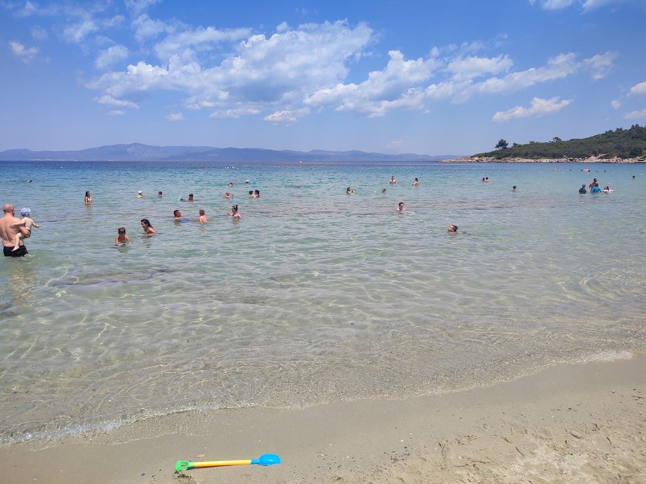 Clear turquoise shallows and pale sand along the Paliouri shore in the Chrousou bay, Kassandra
