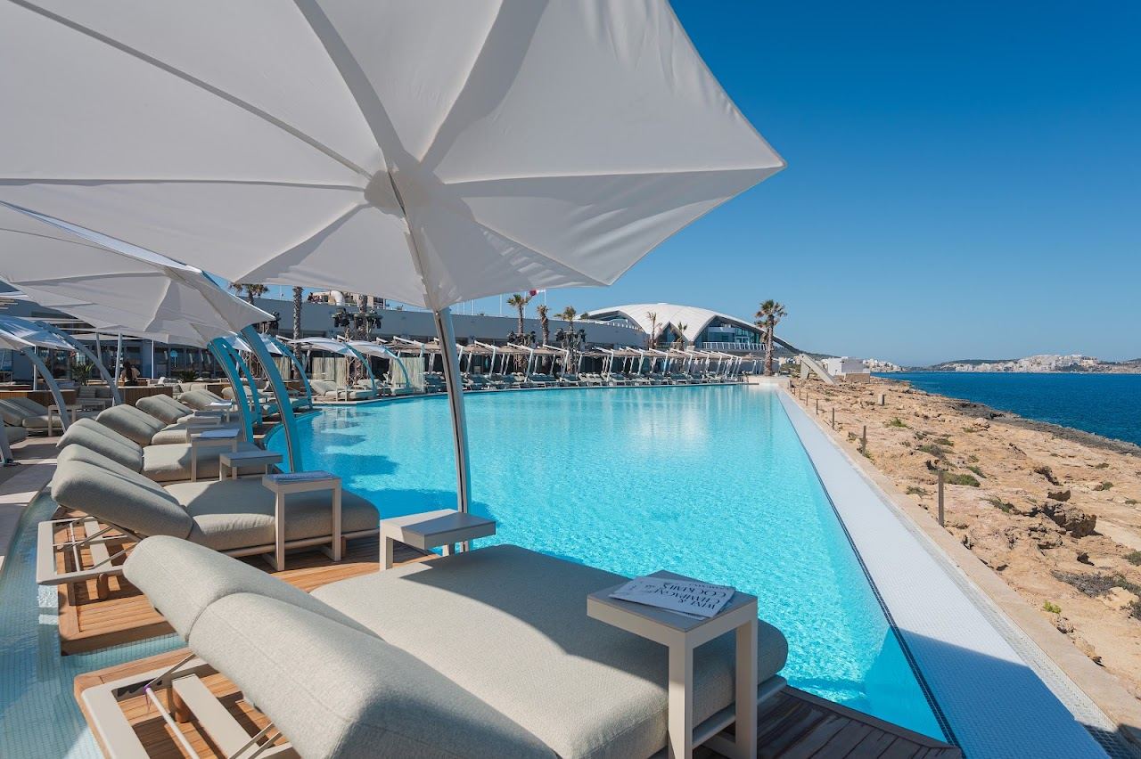 The infinity pool of Cafe del Mar Malta meeting the water of St Paul's Bay at Qawra