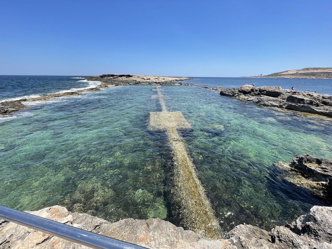 Low rocky shoreline of the Qawra coast on St Paul's Bay, Malta