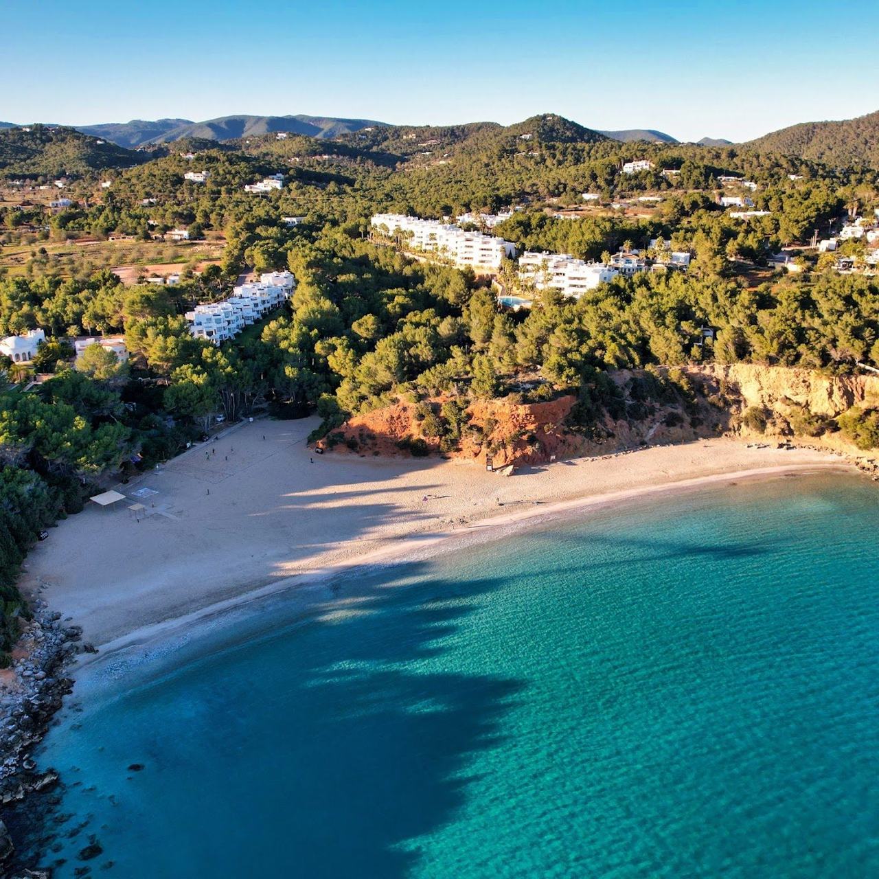 The wide open golden sand and clear shallow water of Cala Llenya near Es Cana on the east coast of Ibiza