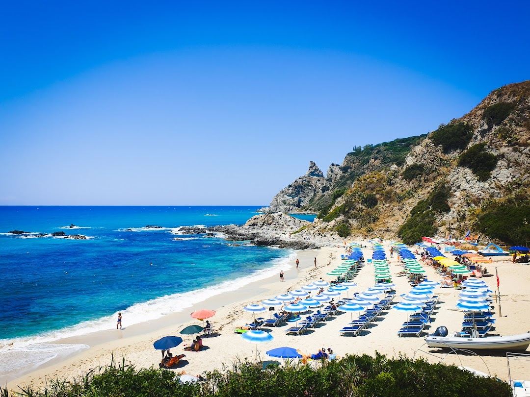 Turquoise water and pale sand below the cliffs of the Costa degli Dei in Calabria